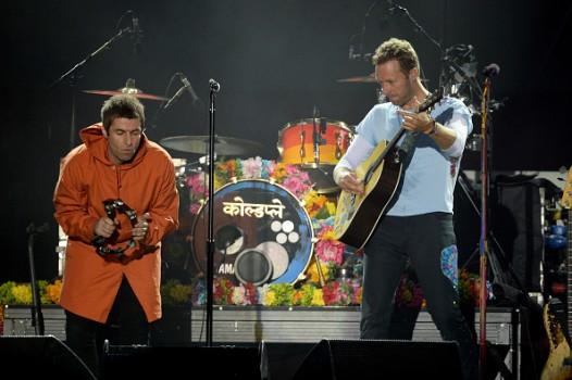 Liam Gallagher and Chris Martin perform on stage on June 4, 2017 in Manchester, England.