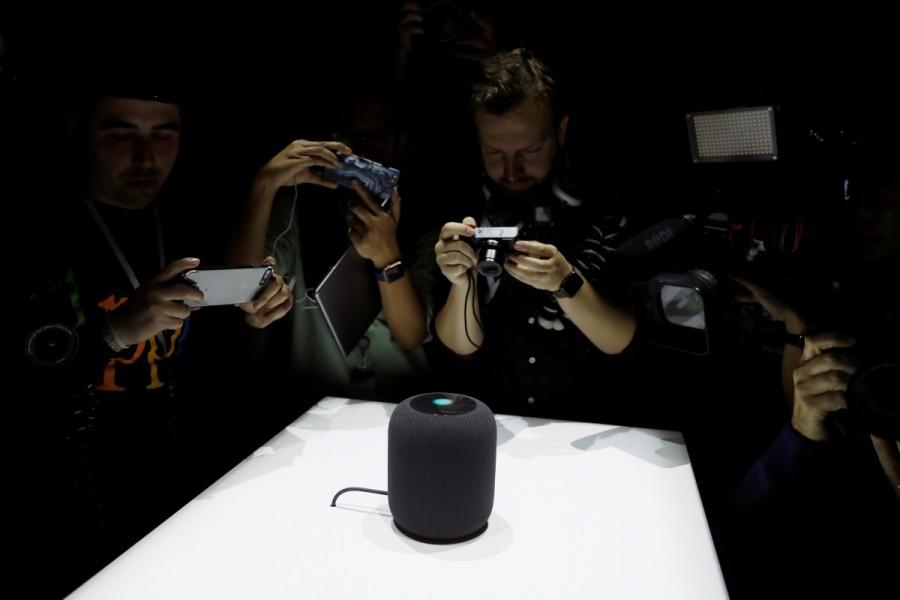 Members of the media photograph a prototype Apple HomePod during the annual Apple Worldwide Developer Conference (WWDC) in San Jose, California. Apple introduced the HomePod, a voice-controlled speaker that can make music suggestions and adjust home temperatures, taking aim at Amazon.com's Alexa feature and Echo devices. WWDC 2017,WWDC,Apple,iMac,MacBook Pro series,Worldwide Developer Conference,Apple HomePod,Apple iMac