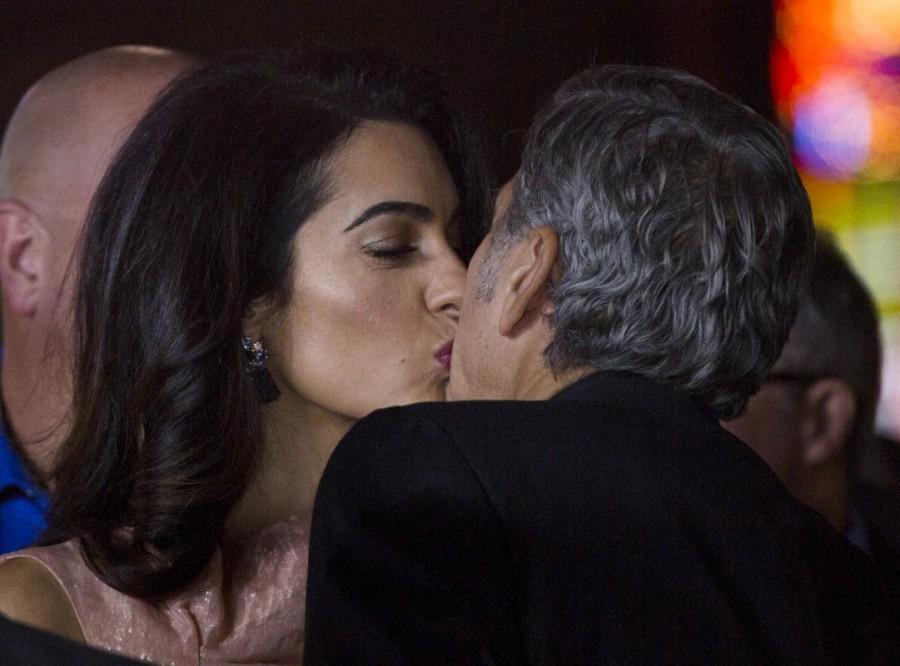 Producer George Clooney kisses his wife Amal at the premiere of "Our Brand Is Crisis" in Hollywood, California October 26, 2015. Amal Clooney,George Clooney,Amal and George Clooney welcome twins,Amal Clooney welcome twins,George Clooney welcome twins