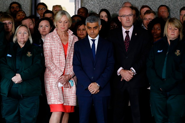 Mayor of London Sadiq Khan (C) stands with ambulance paramedics as they pause for a minutes' silence in London on June 6, 2017, in memory of the victims of the June 3 terror attacks. Police on Monday identified two of the three London attackers as Khuram Butt and Rachid Redouane, after Britain's third terror assault in less than three months, as Prime Minister Theresa May came under mounting pressure over security just days ahead of elections. London Bridge Terror Attack,London Bridge,victims of London Bridge terror attack,Minute's silence held for victims of London Bridge terror attack