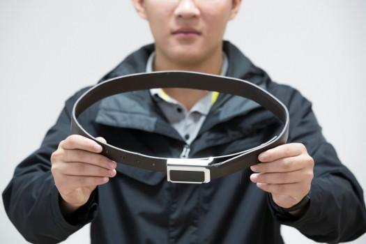 A man holds a wireless device disguised as a belt during a presentation to the media in Taiyuan, Shanxi province, China June 6, 2017. Equipment seized over the years, used in cheating attempts by students sitting for the national college entrance exam known as 