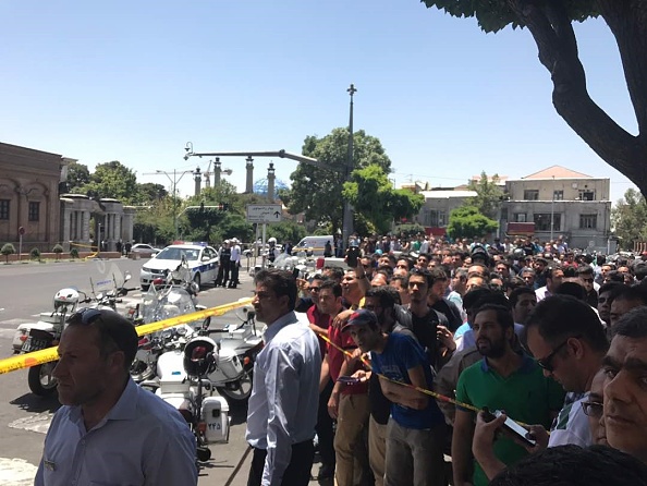 Police take security measures and people wait near the scene after gunmen opened fire at Irans parliament and the shrine of Ayatollah Khomeini in the capital Tehran, Iran on June 7, 2017. Gunmen attack,Gunmen attack Iranian parliament,Iranian parliament,Iranian Parliament building,Khomeini shrine,Tehran