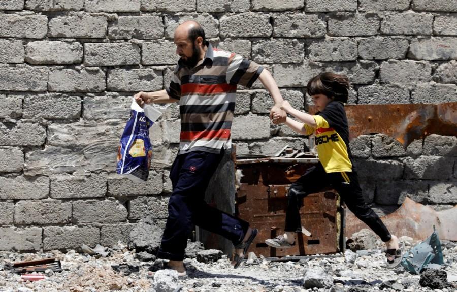 A man and his daughter, displaced by fighting between Iraqi forces and Islamic State militants, run to a safer area. Western Mosul,Mosul,Islamic State,Children flee,Islamic State’s last