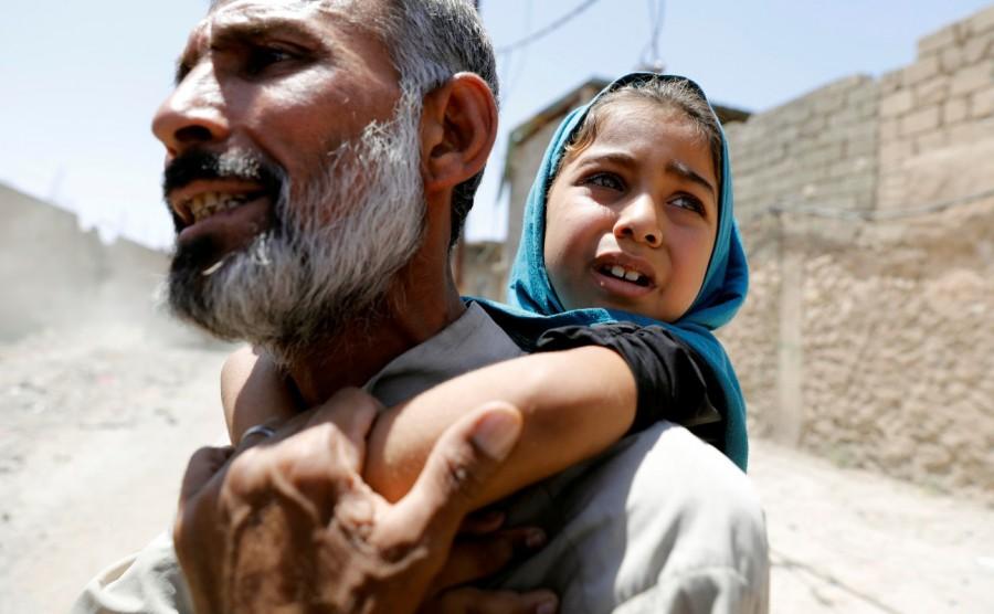 A man carries his daughter on his back after fleeing their home due to fighting between the Iraqi forces and Islamic State militants in Mosul's al-Zanjili's district in Iraq June 7, 2017. Western Mosul,Mosul,Islamic State,Children flee,Islamic State’s last