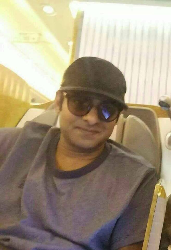 Picture of "Baahubali" fame Prabhas in his clean shaven avatar has taken the internet by storm. Fans believe this could be his look for his upcoming Telugu actioner "Saaho". The picture, apparently clicked on a flight, features a Prabhas sporting shades, wearing a cap, and clean shaven. There are thousands of tweets on this look being Prabhas's avatar from "Saaho". The 37-year-old is back from his month-long US holiday. Baahubali,Prabhas,Prabhas clean shaven look,Prabhas shaven look,Prabhas look for Saaho,Saaho,Prabhas avatar,Prabhas shaven avatar