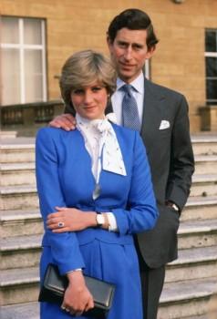 Lady Diana Spencer (later to become Princess of Wales) reveals her sapphire and diamond engagement ring while she and Prince Charles, Prince of Wales pose for photographs in the grounds of Buckingham Palace following the announcement of their engagement.