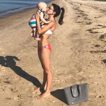 Hilaria Thomas Baldwin flaunts her bikini body as she hits the beach with Alec and the kids.