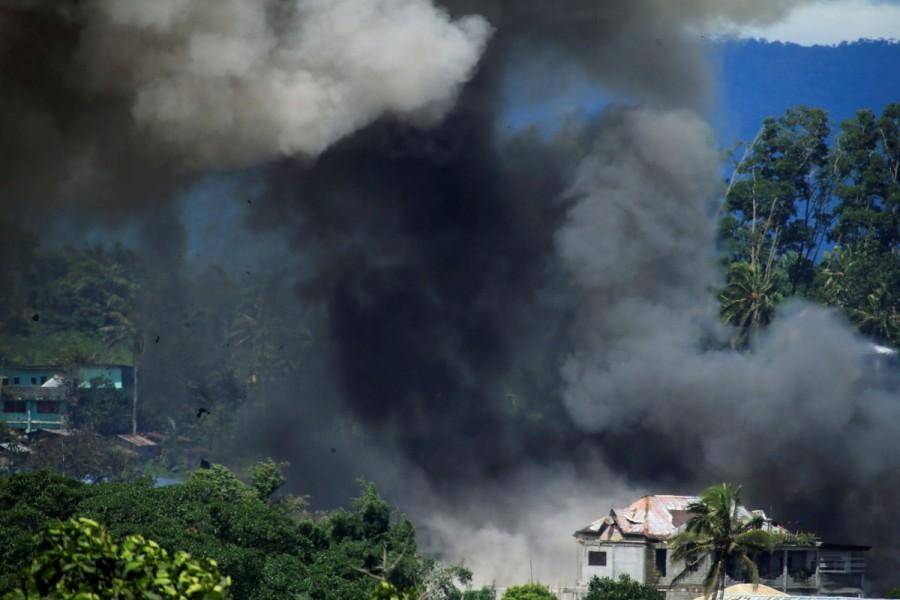 Black smoke comes from a burning building is seen after government troops' continuous assault with insurgents from the so-called Maute group, who has taken over large parts of the Marawi City, Philippines. Philippines battles Islamist fighters,Islamist fighters,Marawi City,Islamic State,Syria,Iraq,Philippine island