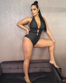 American model Ashley Graham shows her body in plunging swimsuit.