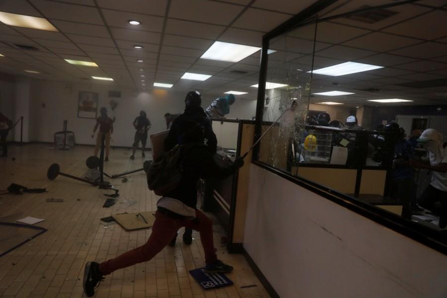 Protesters vandalize a bank branch, housed in the magistracy of the Supreme Court of Justice, during a rally against Venezuela's President Nicolas Maduro, in Caracas. Venezuela Supreme Court office,Protesters attack Venezuela Supreme Court office,Protesters angry
