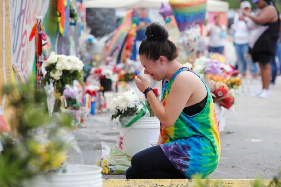 Chelsea Nylen reacts while visiting the memorial outside the Pulse Nightclub on the one-year anniversary of the shooting in Orlando, Florida. Orlando,Orlando Pulse nightclub massacre,Pulse nightclub massacre,Pulse nightclub,first anniversary of Orlando's Pulse nightclub,Pulse Nightclub,pulse nightclub shooting