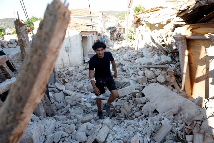 A man walks among collapsed buildings at the village of Vrissa on the Greek island of Lesbos, Greece, after a strong earthquake shook the eastern Aegean. Earthquake strikes Greek,Earthquake strikes Lesbos,Greek island,Greek island of Lesbos