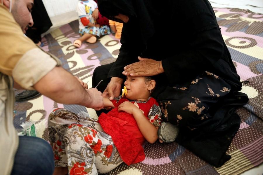 A displaced Iraqi girl is treated in a field hospital at the Hasansham U2 camp, where more than 300 people fell ill in a mass outbreak of food poisoning, in al-Khazer, east of Mosul, Iraq June 13, 2017. Food poisoning outbreak,Food poisoning,Food poisoning outbreak at Iraqi camp,Iraqi camp,Food poisoning at Iraqi camp,Iraqi city,Mosul