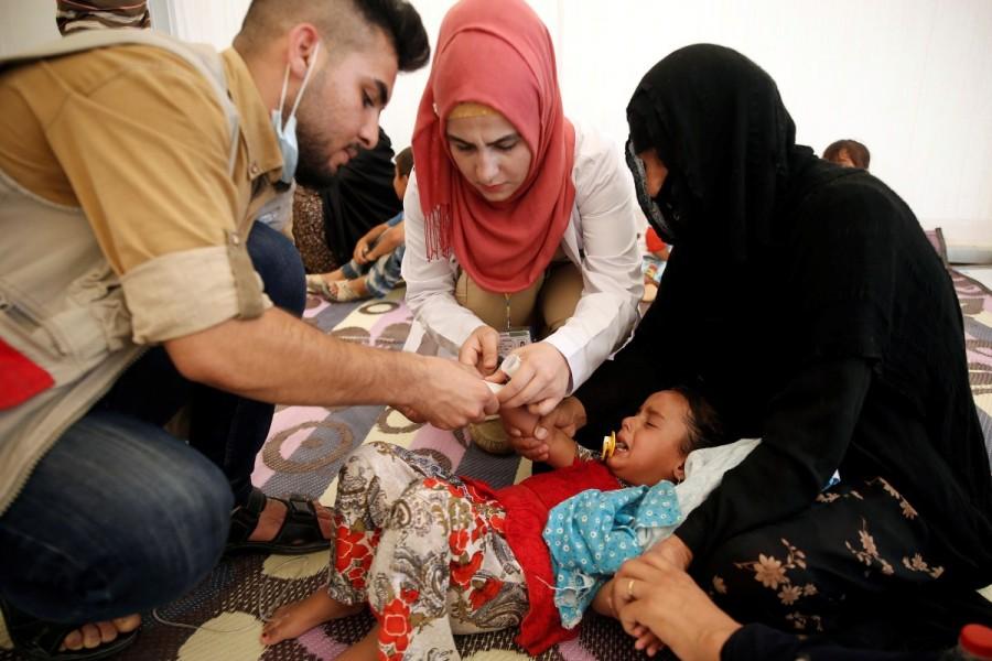 A displaced Iraqi girl is treated in a field hospital at the Hasansham U2 camp, where more than 300 people fell ill in a mass outbreak of food poisoning on June 13, 2017 in al-Khazer, east of Mosul, Iraq Food poisoning outbreak,Food poisoning,Food poisoning outbreak at Iraqi camp,Iraqi camp,Food poisoning at Iraqi camp,Iraqi city,Mosul