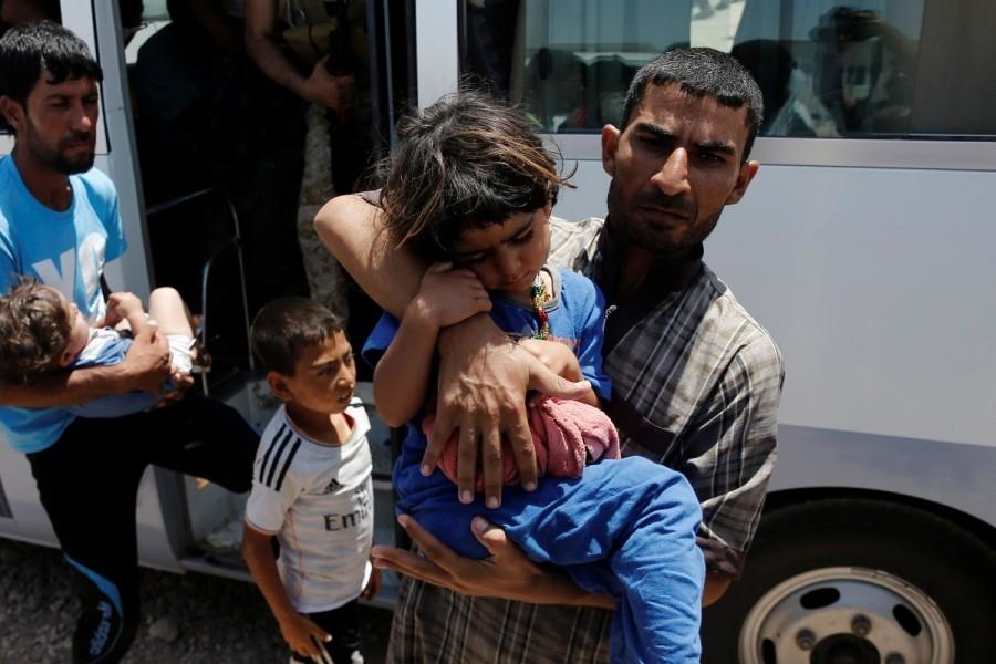 Displaced Iraqi people who fell ill in a mass outbreak of food poisoning, return on a bus after being treated in regional hospitals, at the Hasansham U2 camp in al-Khazer, east of Mosul, Iraq June 13, 2017. Food poisoning outbreak,Food poisoning,Food poisoning outbreak at Iraqi camp,Iraqi camp,Food poisoning at Iraqi camp,Iraqi city,Mosul