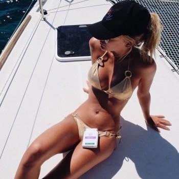 MIC's Tiffany Watson displays her assets in bronze thong bikini.