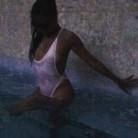 Radio personality Angela Jordan shows off bountiful curves in plunging swimsuit.