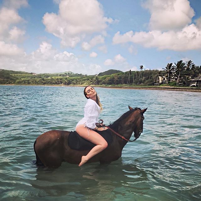 Swimsuit-clad Little Mix's Perrie Edwards rides a horse in the ocean. Perrie Edwards,Little Mix's Perrie Edwards,Perrie Edwards bikini pics,Perrie Edwards bikini images,Perrie Edwards bikini stills,Perrie Edwards curves,Perrie Edwards curves pics,Perrie Edwards flaunts curves,Perrie Edwards curves pics,Perrie Edwards c