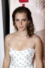 Emma Watson shows her sensational figure in a beautiful plunging white gown.
