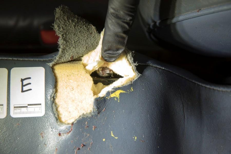 An investigator lifts fabric to show a bullet lodged in the car. Philando Castile shooting,Philando Castile,philando castile death,Philando Castiles girlfriend,Yanez fatally shot