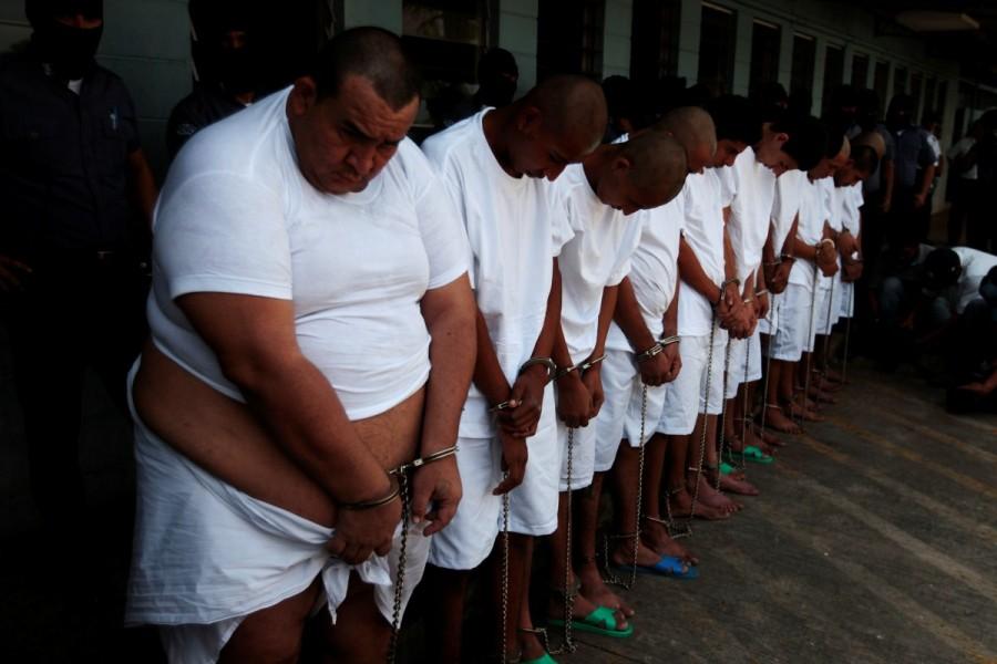 MS-13 gang members wait to be escorted upon their arrival at the maximum-security jail in Zacatecoluca. MS-13 gang,MS-13,MS-13 gang members,Members of MS-13,El Salvador,crime-ravaged,Central American nation