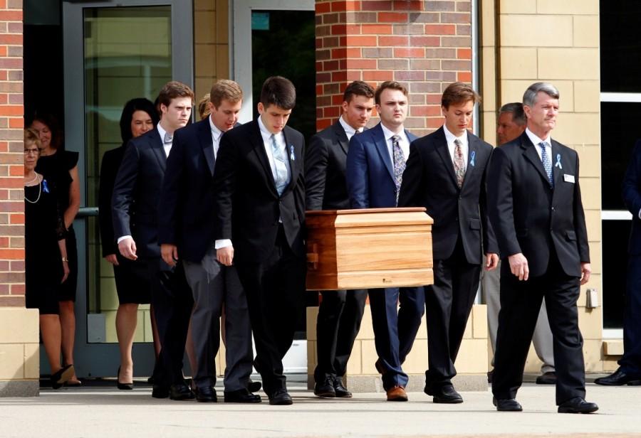 The casket of Otto Warmbier is carried to the hearse followed by his family and friends after his funeral service at Wyoming High School in Wyoming, Ohio. Funeral for student,Funeral for student held prisoner,Otto Warmbier,United States