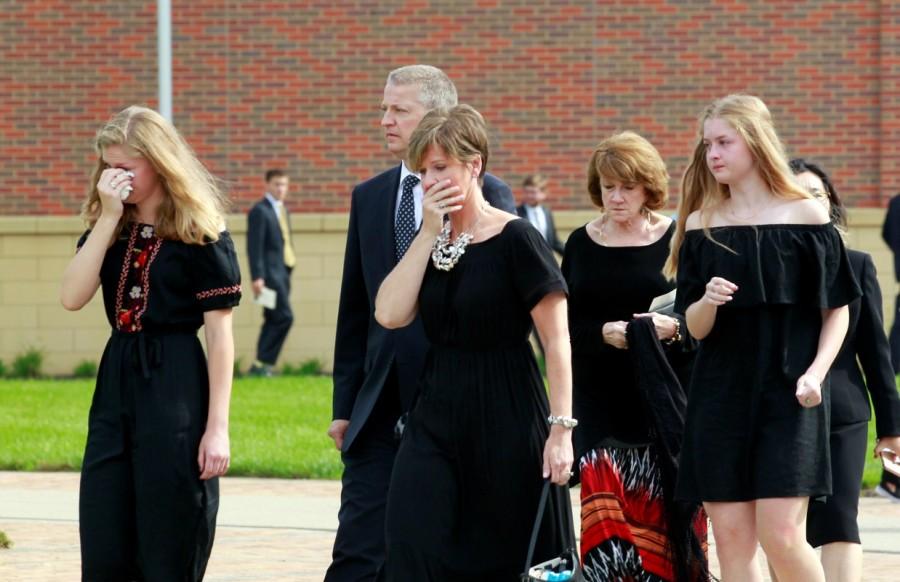 Mourners grieve as the hearse carrying Otto Warmbier departs for the cemetery at Wyoming High School in Wyoming, Ohio. Funeral for student,Funeral for student held prisoner,Otto Warmbier,United States