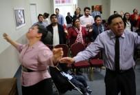 Honduran migrants Raul Contreras, his mother Daysi Alas (C) and step-father Ananin Cruz attend a church service held in Spanish in Toronto. Thousands of people who fled to Canada to escape President Donald Trump’s crackdown on illegal migrants have become trapped in legal limbo because of an overburdened refugee system, struggling to find work, permanent housing or enroll their children in schools.