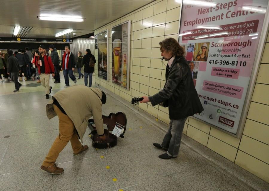 Raul gives money to a subway entertainer while travelling to a church service. Raul, who spends his days at a local library or working out in the hotel gym, says he has been repeatedly rejected by landlords. "They just said that they didn't rent places to refugee claimants," he said. "(They) said that refugees don't have jobs and probably wouldn't pay." Asylum seekers stuck,Canadian legal limbo,President Donald Trump,Donald Trump,illegal migrants,refugee