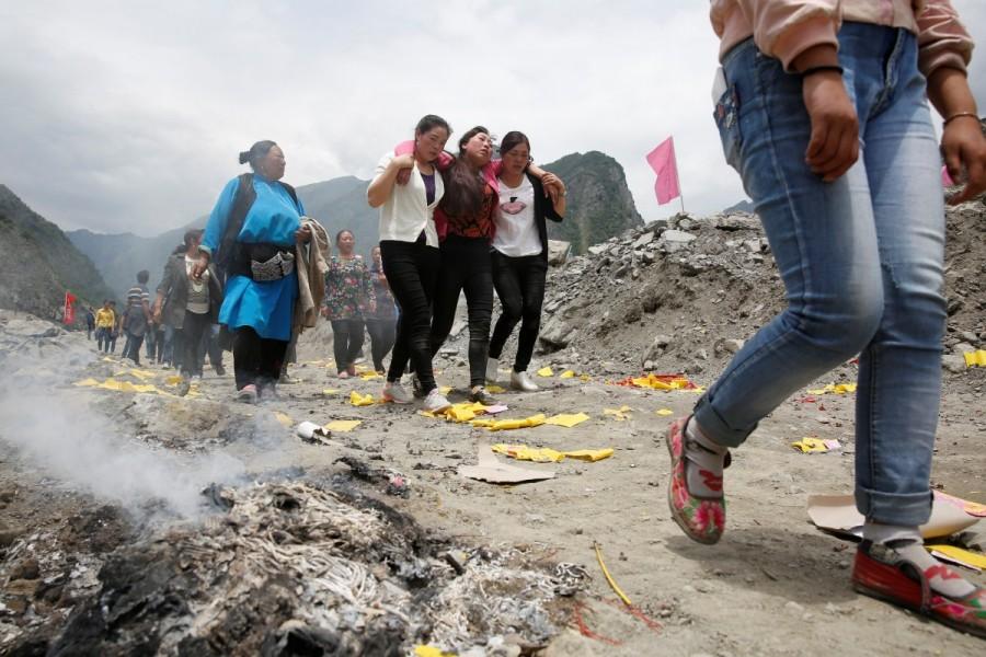 Relatives of victims react at the site of a landslide in the village of Xinmo, Mao County, Sichuan Province. Landslide buries Chinese village,Chinese village,Sichuan province,Xinmo village,Xinmo village China landslide