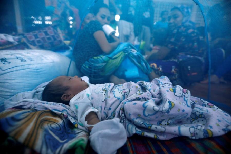 An evacuated newborn sleeps inside a mosquito net at an evacuation center outside Marawi, as government forces continue their assault against insurgents from the Maute group in Marawi, Philippines. Islamic State,Marawi City,Philippine evacuees wait out fighting