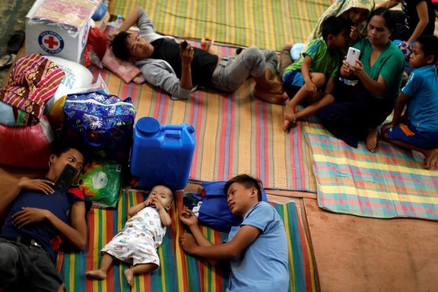 Evacuated residents lie on the floor at an evacuation center outside Marawi. Islamic State,Marawi City,Philippine evacuees wait out fighting
