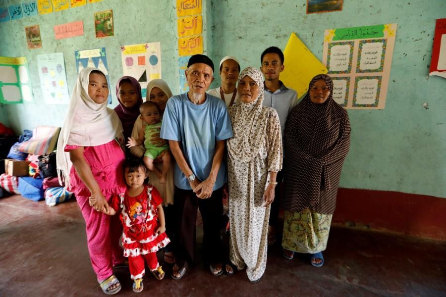 Edris Candidato and his family pose for a picture inside a classroom in a madrasa used as an evacuation center. Islamic State,Marawi City,Philippine evacuees wait out fighting