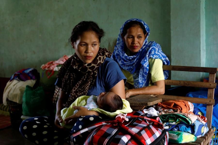 A evacuated mother Rohanifa carries her 2-weeks-old baby Raifah who was born at the evacuation center. Islamic State,Marawi City,Philippine evacuees wait out fighting