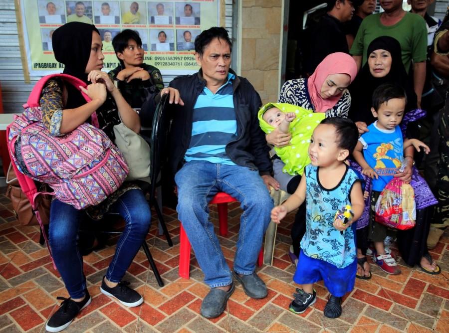 Rescued residents take a rest after they were rescued from their homes. Islamic State,Marawi City,Philippine evacuees wait out fighting
