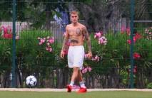 Shirtless Justin Bieber flaunts his six-pack.