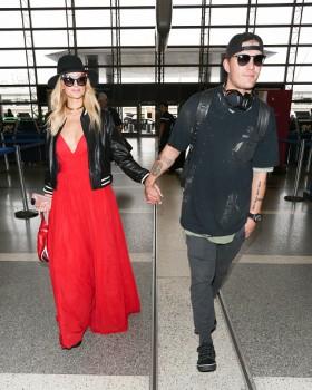 Paris Hilton and Chris Zylka are seen at LAX.