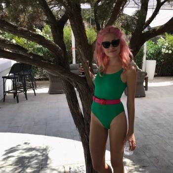 Pixie Lott shows her pink neon hair in racy high-cut swimsuit.
