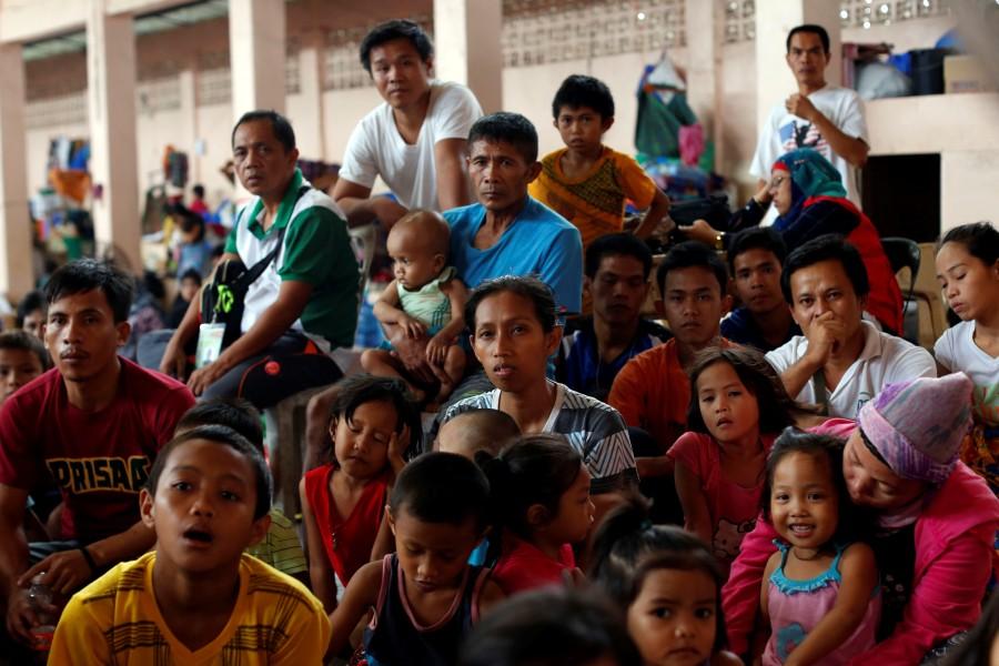 Displaced Marawi residents react as they watch the boxing fight between Manny Pacquiao of the Philippines and Australia's Jeff Horn during the WBO World Welterweight Title, at an evacuation center in Baloi. Philippine city,Battle of Philippine city,Marawi City,fight rebels,Islamic State