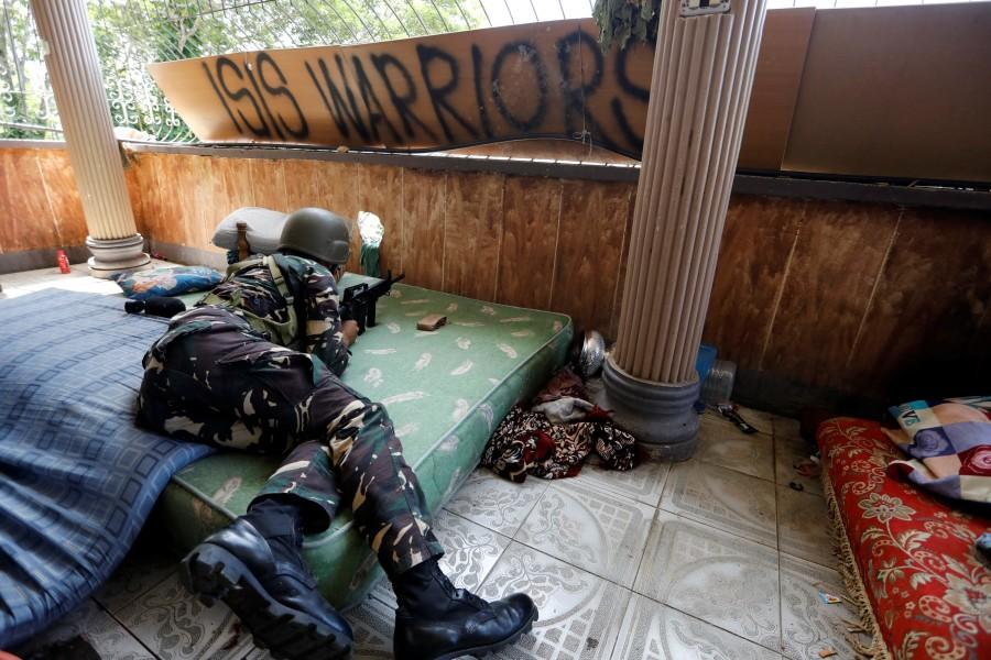 A Filipino soldier lies on a mattress at their combat position in a house as government troops continue their assault against insurgents from the Maute group in Marawi city. Philippine city,Battle of Philippine city,Marawi City,fight rebels,Islamic State