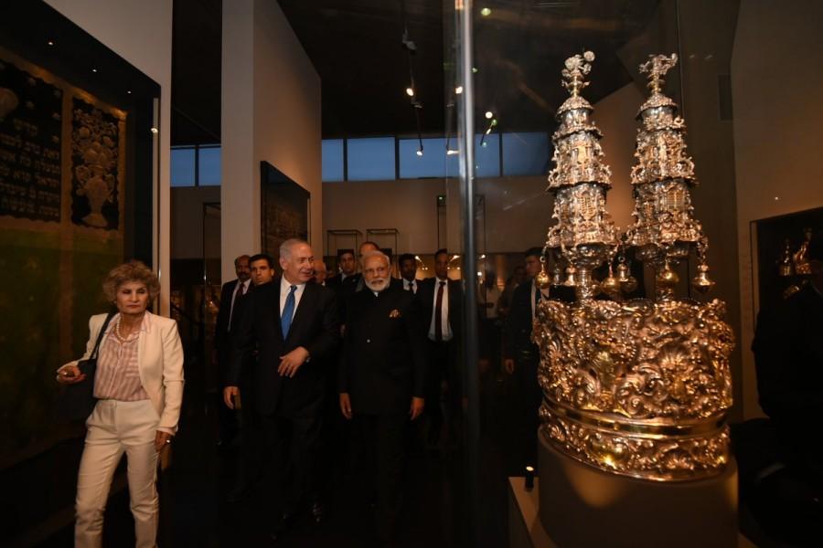 The leaders also saw a set of Torah scrolls in silver casings which were earlier displayed in the Magen David synagogue during Simhat Torah in Kolkata. The highlight of the tour was a stop at the replica of the Kadavumbagam synagogue from Kochi, built in the 16th century. Its wooden structures, with a carved and painted ceiling and the ornate altar are placed in a room. The main wooden structure was brought in from the original synagogue. Narendra Modi,PM Narendra Modi,Prime Minister Narendra Modi,Israeli Premier Benjamin Netanyahu,Benjamin Netanyahu,Israel Museum,Indian Jewish heritage