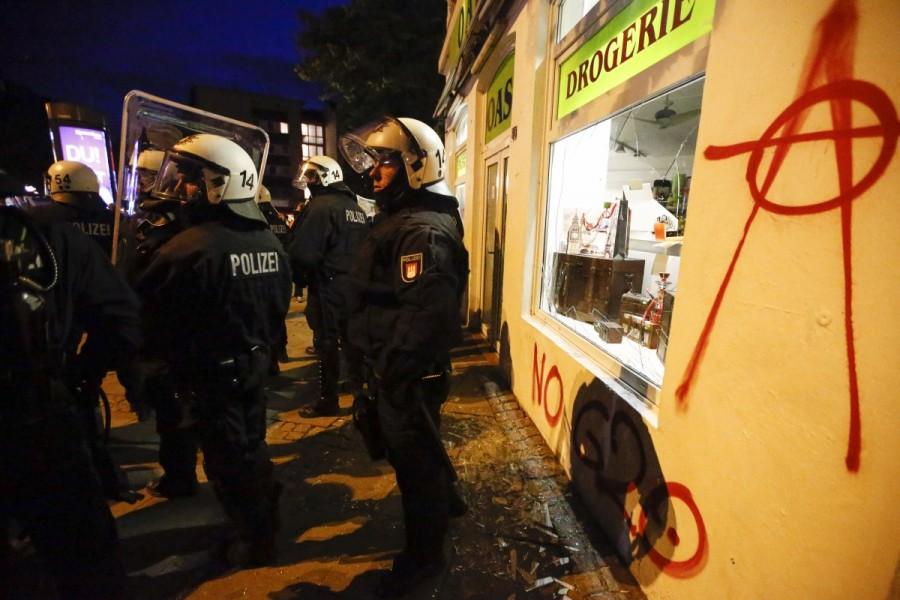 German riot police stand guard during a demonstration. G20 protests,G20,G20 protests Germany,clash in Germany,G20 summit