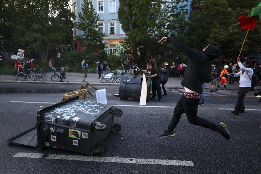 A protester throws an object towards riot police during clashes with anti-G20 protesters. G20 protests,G20,G20 protests Germany,clash in Germany,G20 summit