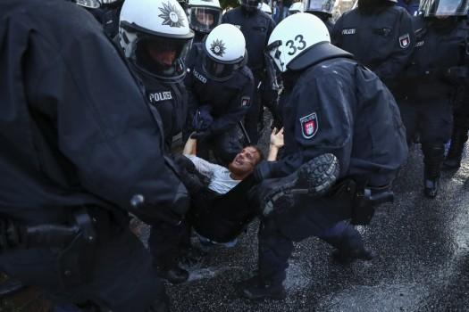 German riot police detain a protester during clashes with anti-G20 protesters.