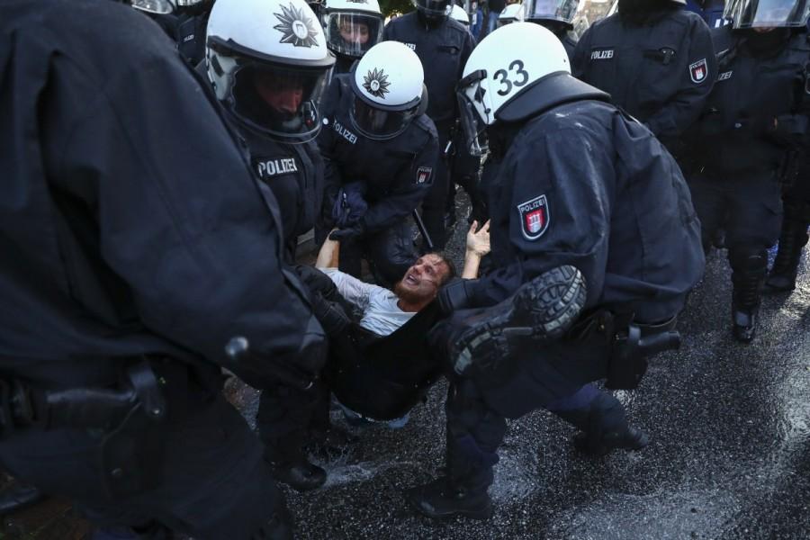German riot police detain a protester during clashes with anti-G20 protesters. G20 protests,G20,G20 protests Germany,clash in Germany,G20 summit