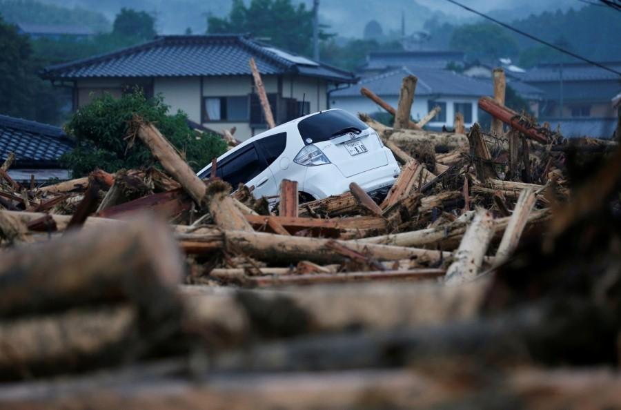 A damaged car is seen at an area hit by heavy rain in Asakura, Fukuoka Prefecture, Japan. Deadly deluge in Japan,Japan Deadly deluge,southwestern Japan,rains battered southwestern Japan,rain battered Japan,Torrential rain,Torrential rain in Japan