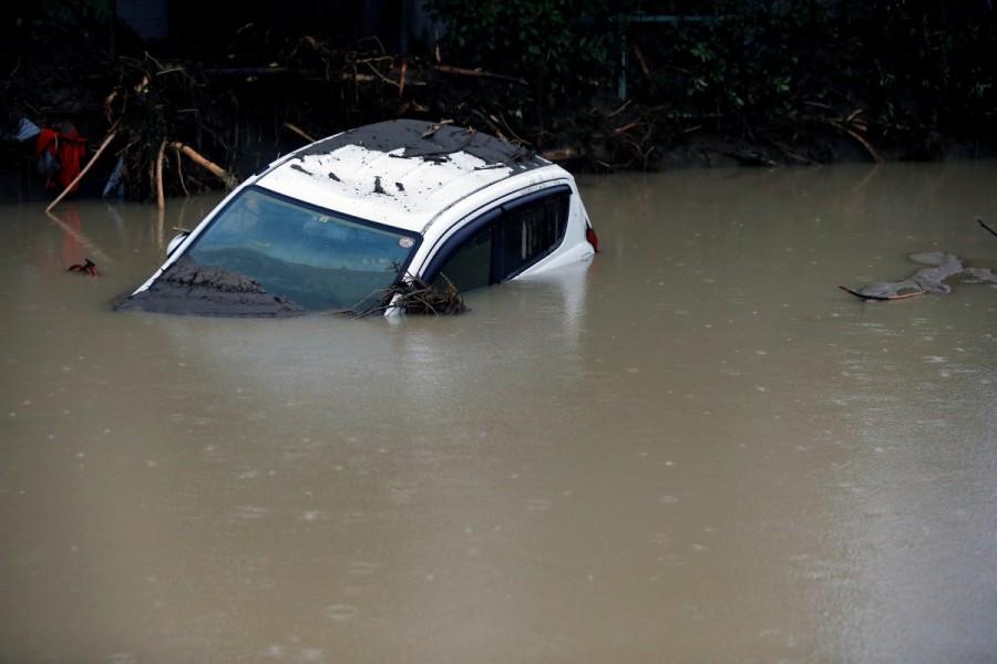 A car damaged by a swollen river is seen after heavy rain hit the area in Asakura, Fukuoka Prefecture. Deadly deluge in Japan,Japan Deadly deluge,southwestern Japan,rains battered southwestern Japan,rain battered Japan,Torrential rain,Torrential rain in Japan
