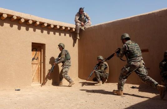A U.S. Marine watches Afghan National Army soldiers during a training in Helmand province.