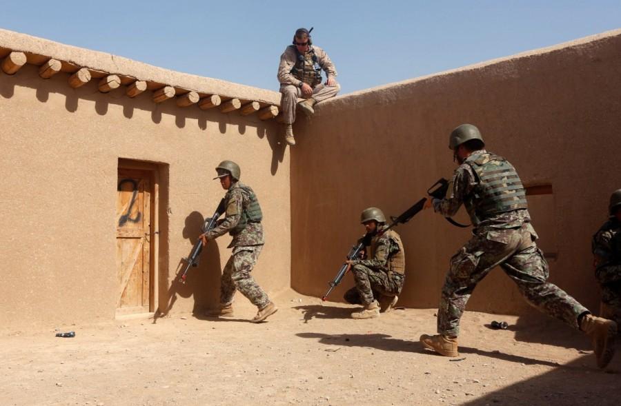 A U.S. Marine watches Afghan National Army soldiers during a training in Helmand province. Afghan National Army,Afghan National,National Army,U.S. Marines,U.S. Marines train,Taliban insurgency
