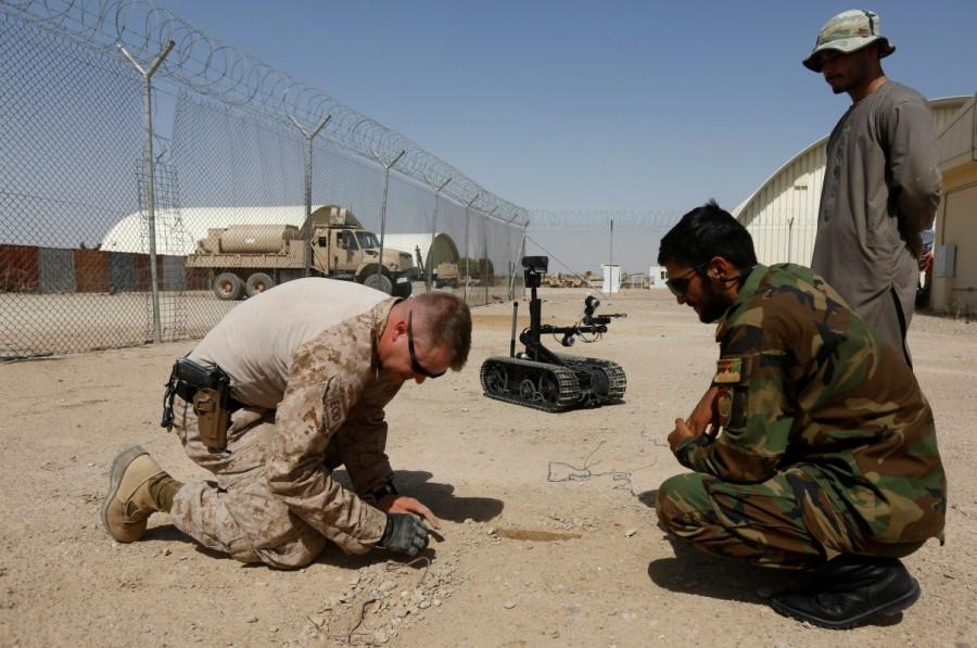 A U.S. Marine prepares a mine clearance exercise with Afghan National Army soldiers as part of training operations in Helmand. Afghan National Army,Afghan National,National Army,U.S. Marines,U.S. Marines train,Taliban insurgency